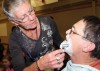 Suzann Hatton uses a razor to shave Craig Whitehead’s beard.