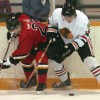Tanner Benns of the Fort Macleod Mustangs battles along the boards with Brendyn Lanz of the Brooks Black Hawks.