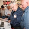 Former Granum White Sox players Jim MacDonald and Gord Vejprava look at one of the scrapbooks about their team.
