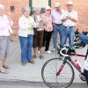 Rev. Eras Van Zyl cycles down Main Street on Friday followed by the Fort Macleod Handibus.