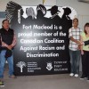 The sign proclaiming Fort Macleod a member of the Canadian Coalition Against Racism and Discrimination was unveiled Thursday at the Fort Macleod Arts Building. From left: Wesley Morrissette, Peter Weasel Moccasin, Raj Parmar, Jasmine Walburger and David Blair Mason of the Alberta Human Rights Commission.