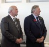 Hank Arnoldussen, John Davis Jr. and David Arnoldussen with the three prints by Gerald Goldenbeld depicting key buildings and people in the history of Scougall Motors.