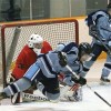Fort Macleod Mustangs goalie Cody Hall sprawls to make a save off a falling Lomond Lakers player