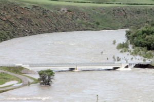A portion of the bridge is washed out just downstream from the Oldman dam.