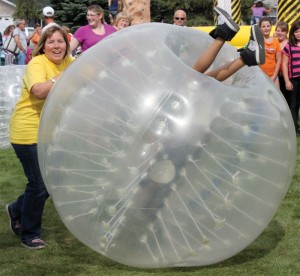 Fort Macleod Drug Coalition member Angie O'Connor pushes someone inside a bumper ball at the 2012 Party in the Park.