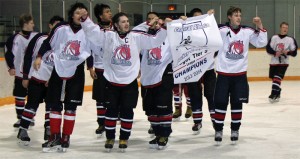 Fort Macleod Mavericks captain Colten Holtz and assistant captain Riley Vanee and their teammates take a victory lap with the banner.