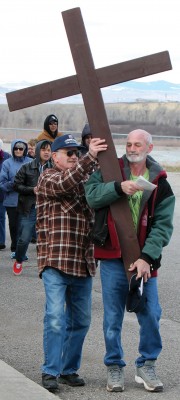 The foothills provided a scenic background for Joe Hamacher (left) eases Chris Adamiak's burden by taking the wooden cross from his shoulder. 