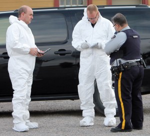 Cpl. Bryan Mucha (right) talks with members of the forensic team.