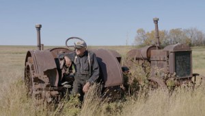 Sitting on one of his family's old tractors, Herb Pidt recalls the challenges and rewards of farm life (CONTRIBUTED)