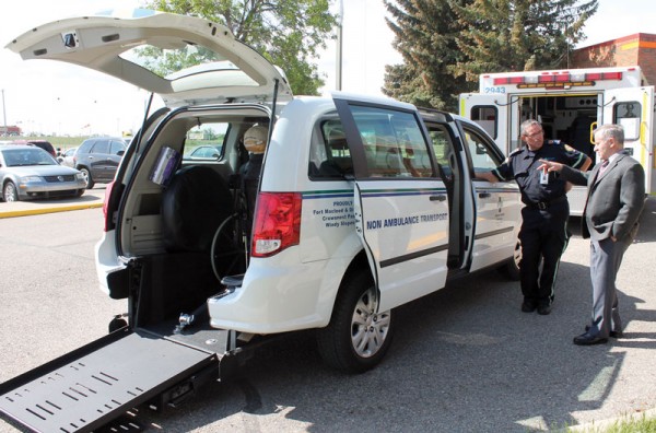 Non-ambulance transfer van driver Ron Lewison discusses the new vehicle with Fort Macleod Mayor Rene Gendre.