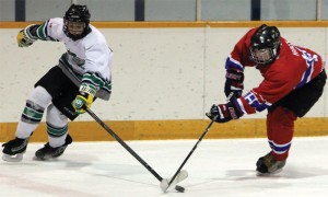 Colten Holtz of the Fort Macleod Mavericks (right) steals the puck from a Claresholm Thunder player