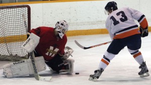Mustangs goalie Joel Pozzo turns away Kainai's Jeremy Weasel Moccasin.