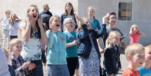 Students celebrate as the helium-filled biodegradable balloons float over Monarch. 