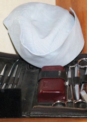 A collection of nursing instruments with an old-style cap.