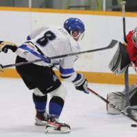Fort Macleod Mustangs goalie Aaron DeKok stops Cole Matson of the Lethbridge Lightning on this scoring attempt, with Jason Stockton in pursuit.