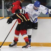 Nolan Tams of the Fort Macleod Mustangs collides with Jacob Charko of the Lethbridge Lightning.