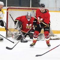 Nanton Palominos Brett Legrandeur prepares to shoot with teammate Brandon Aab and Fort Macleod Mustangs goalie Aaron DeKok and defenceman Jason Stockton waiting in anticipation.