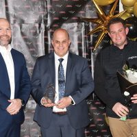 Dallas Romeril of sponsor Huckvale LLP presented the Large Business Award to David Arnoldussen and William Arnoldussen of Scougall Motors.