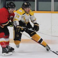 Fort Macleod Mustangs Jason Creighton and Nanton Palominos Jon Stewart battle for the puck.