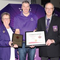 Elks Provincial President Terry Read (left) and Grand Esquire Gordon Moon (right) presented a plaque and certificate to Fort Macleod Elks Exalted Ruler Hank Van Hierden.