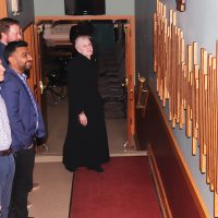 Empress Theatre executive director Hunter Gates explains the new donor board, which is shaped like a sound wave from the Nat King Cole song ‘Unforgettable.’