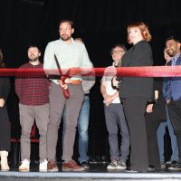 Fort Macleod Mayor Brent Feyter cuts the ribbon to officially reopen the Empress Theatre.