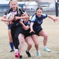 Kendall DeKok of the F.P. Walshe Flyers carries the ball Wednesday against Matthew Halton Hawks.