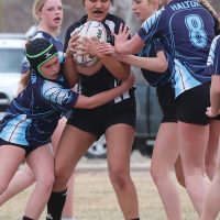 Leslie Bruised Head of the Flyers squeezes the ball tight as she is surrounded by the Matthew Halton Hawks.