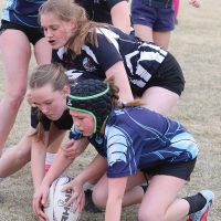 Minnie Toone, Victoria Lodomez and Berlyn Smith of the F.P. Walshe Flyers battle a Matthew Halton Hawk for a loose ball.