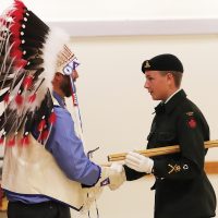Reviewing Officer Jim Bennett shakes hands with Warrant Officer Levi Slingerland.