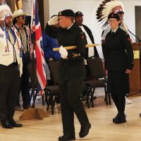 The 2384 Kainai Royal Canadian Army Cadet Corps salute as they march past reviewing officer Jim Bennett.
